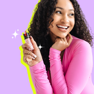 A woman holds Pepper Spray