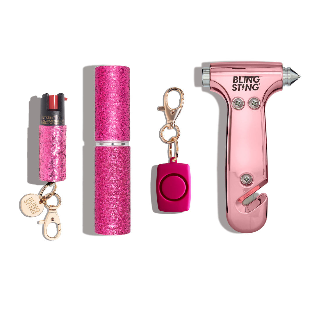 Pink glittery self-defense tools including pepper spray, alarm, and emergency tool.